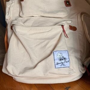 caraa Cream Canvas Backpack with Brown Trim and Red Accents
